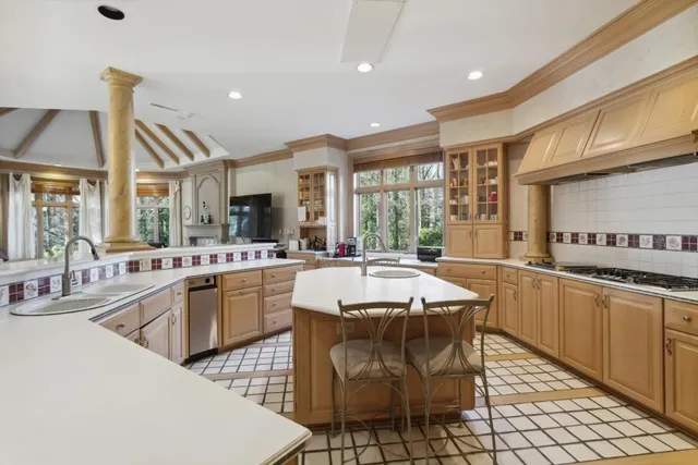 a large kitchen with a table and chairs in it