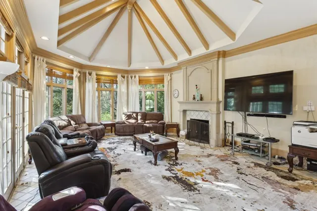 a living room with furniture fireplace and flat screen tv