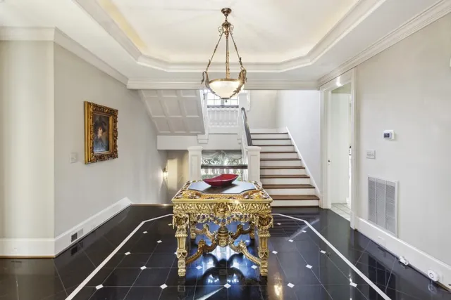 a living room with large window and furniture