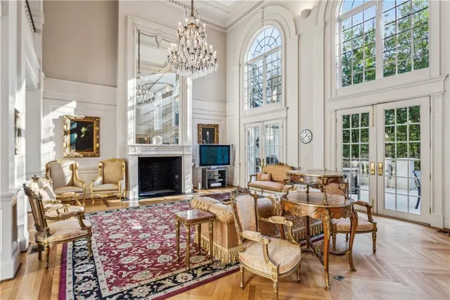 a living room with fireplace furniture and a large window