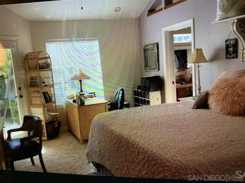 15950 Mactan Road Valley Center, CA 92082 - Photo 12 of 25 a bedroom with a bed and a flat tv screen on dresser