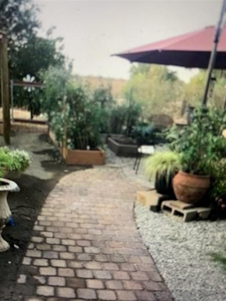 15950 Mactan Road Valley Center, CA 92082 - Photo 16 of 25 a backyard of a house with yard and outdoor seating