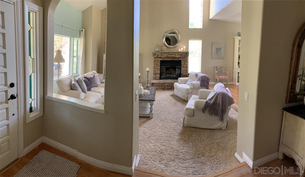 15950 Mactan Road Valley Center, CA 92082 - Photo 6 of 25 a living room with furniture and a fireplace