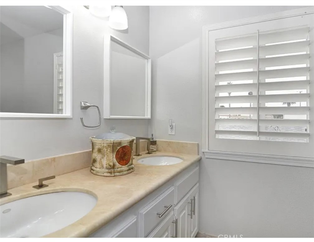 211 8th Street Huntington Beach, CA 92648 - Photo 12 of 16 a bathroom with a granite countertop sink and a window