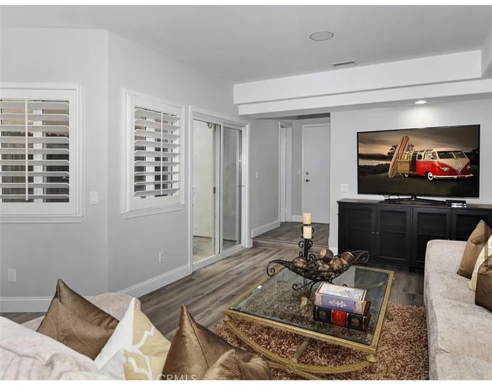 211 8th Street Huntington Beach, CA 92648 - Photo 2 of 16 a living room with furniture and a flat screen tv