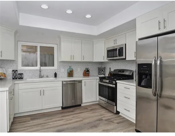 a kitchen with a sink cabinets and stainless steel appliances