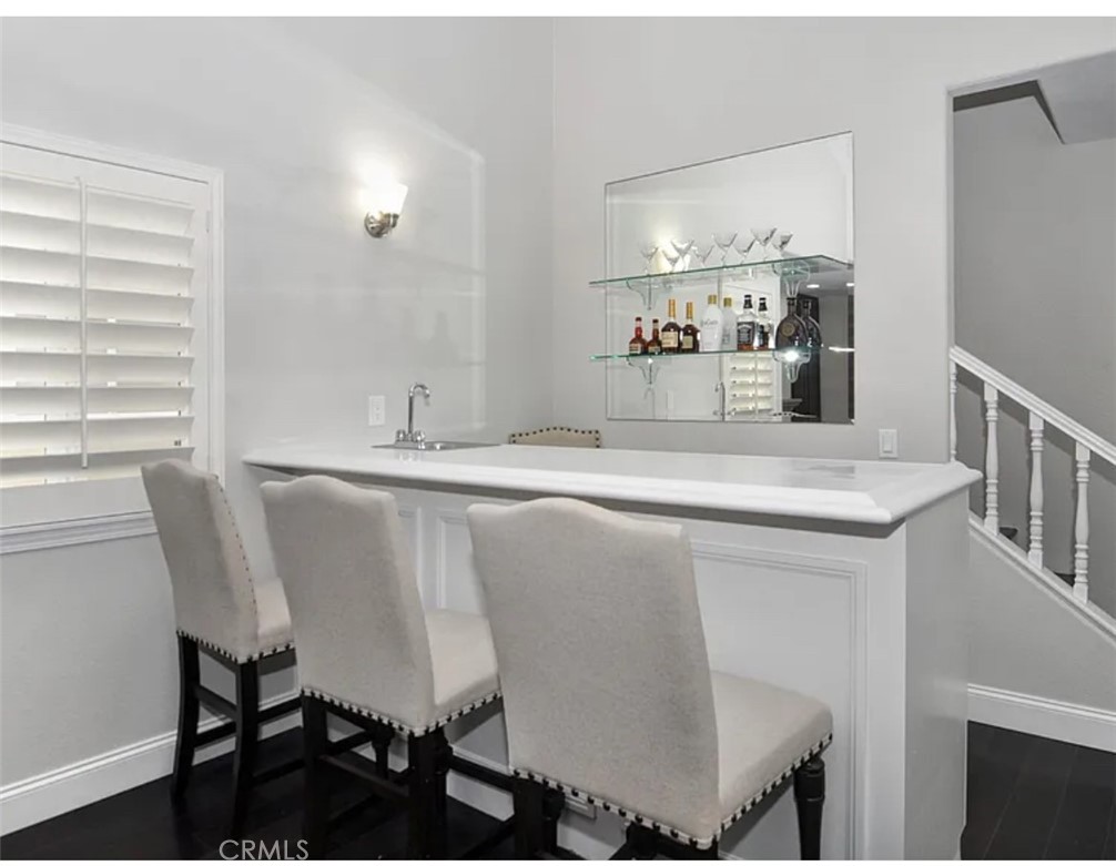 211 8th Street Huntington Beach, CA 92648 - Photo 5 of 16 a dining table chairs and refrigerator in a kitchen