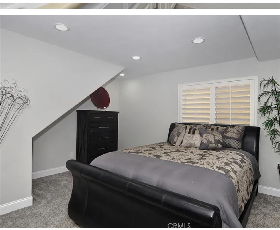 211 8th Street Huntington Beach, CA 92648 - Photo 8 of 16 a bedroom with a bed and a painting on the wall