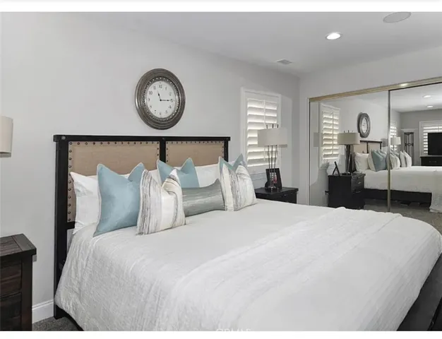 a bed room with a bed and a lamp