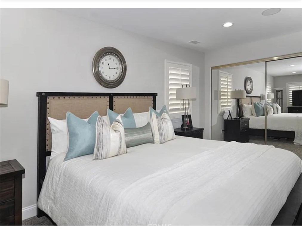 211 8th Street Huntington Beach, CA 92648 - Photo 9 of 16 a bed room with a bed and a lamp