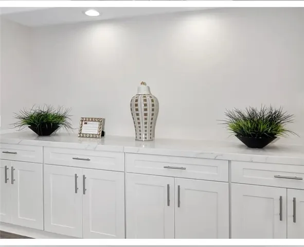 a view of kitchen with cabinets and wooden floor