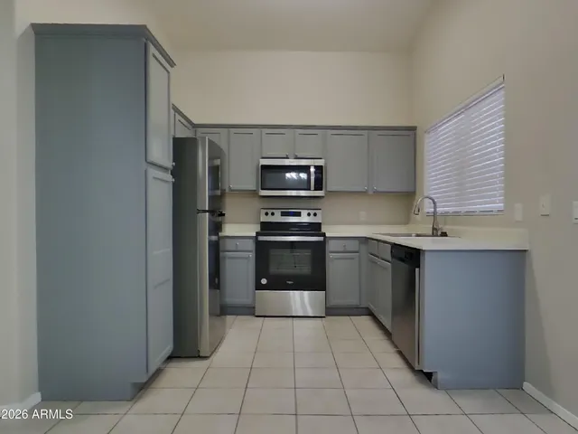 a kitchen with a stove top oven and cabinets