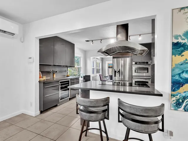 a kitchen with a sink and stainless steel appliances