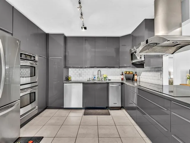 a kitchen with stainless steel appliances a sink and a stove
