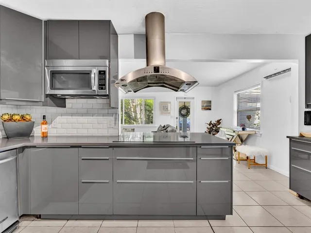 a kitchen with stainless steel appliances a sink and cabinets
