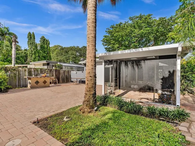 a bathroom with a granite countertop sink a shower and a mirror
