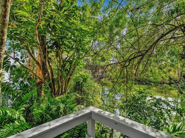 a view of an empty room with floor to ceiling window and an outdoor view