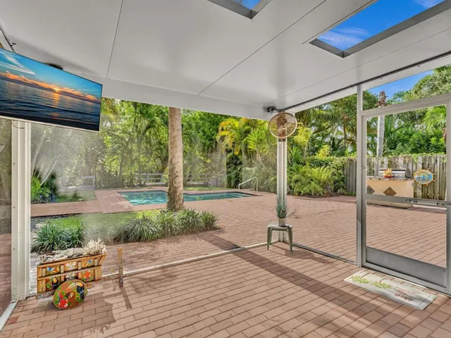front view of a house with a yard and potted plants
