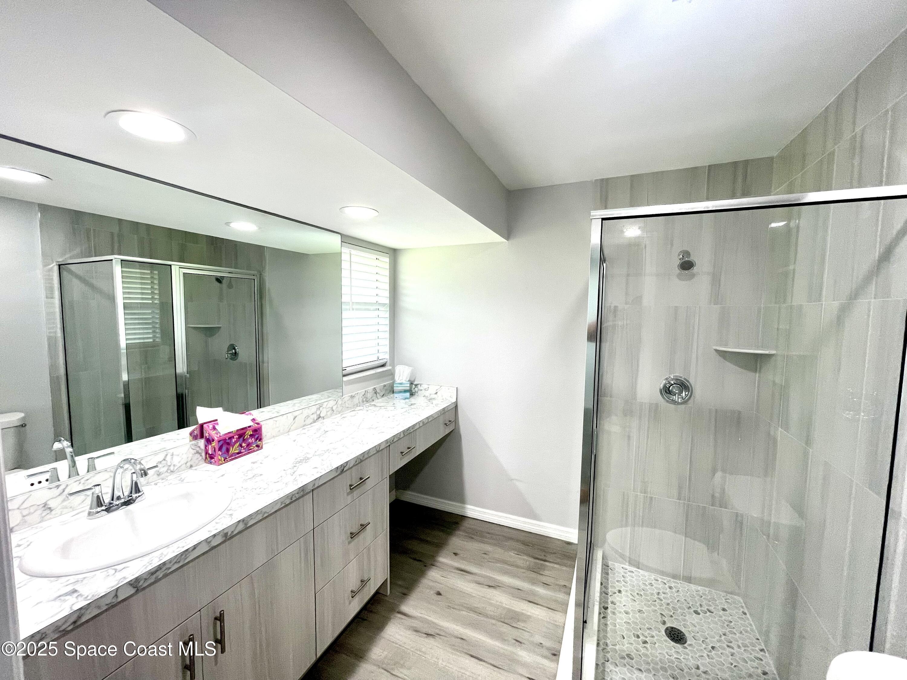 1186 Galty Circle Northeast, Unit 6 Palm Bay, FL 32905 - Photo 14 of 26 a bathroom with a granite countertop shower sink and mirror