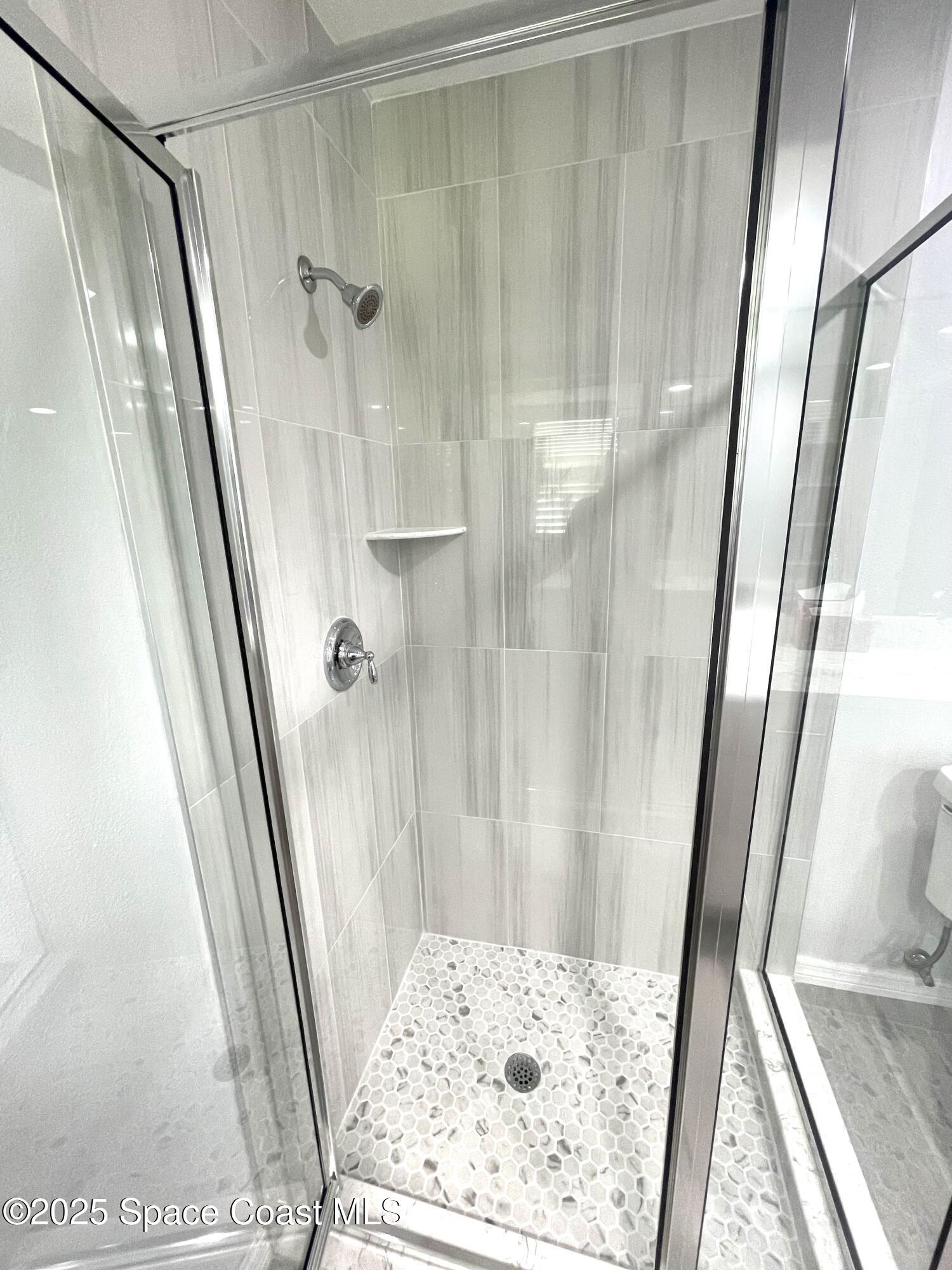 1186 Galty Circle Northeast, Unit 6 Palm Bay, FL 32905 - Photo 15 of 26 a bathroom with a tub and a shower