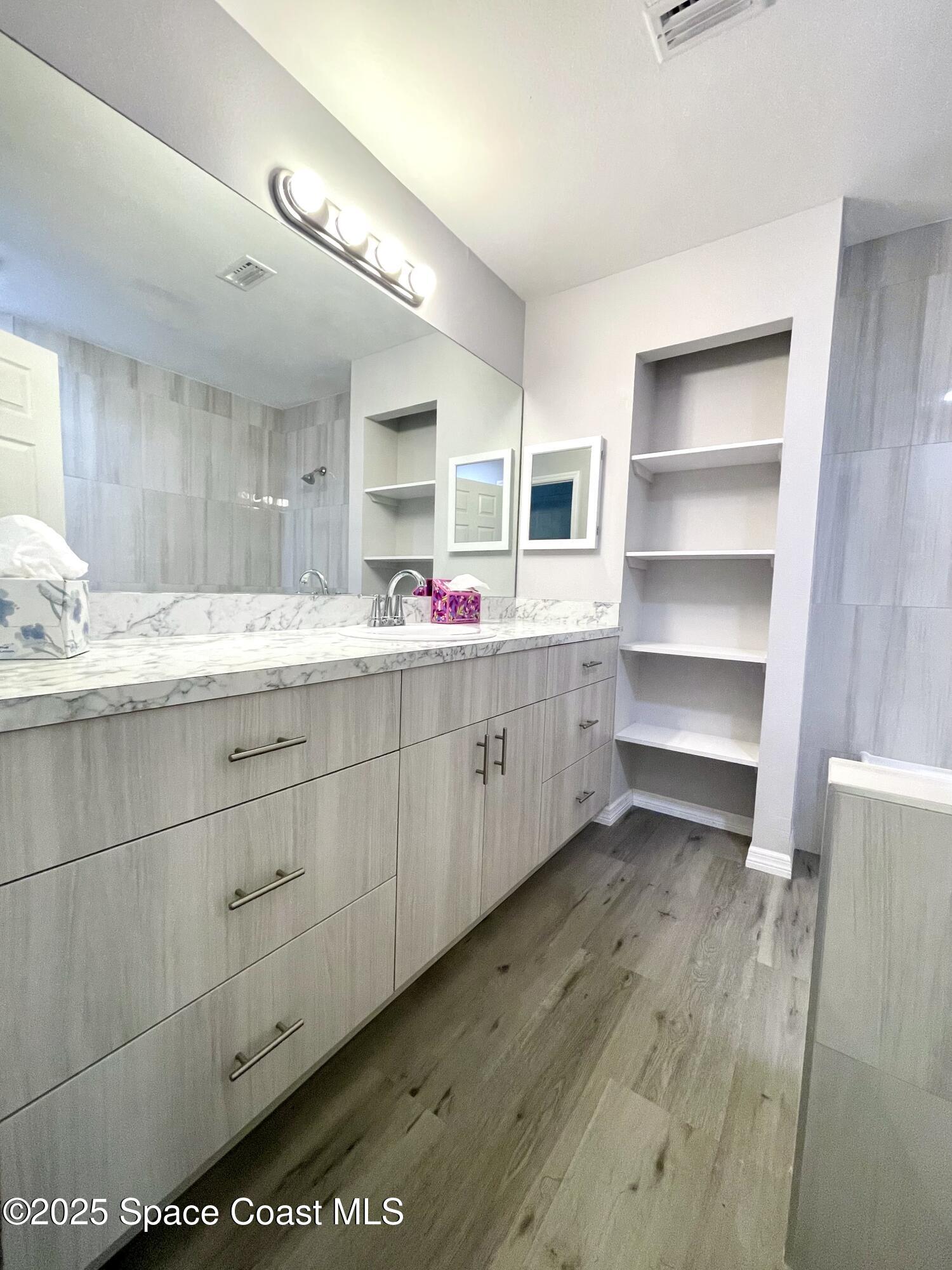 1186 Galty Circle Northeast, Unit 6 Palm Bay, FL 32905 - Photo 19 of 26 a kitchen with a sink and cabinets
