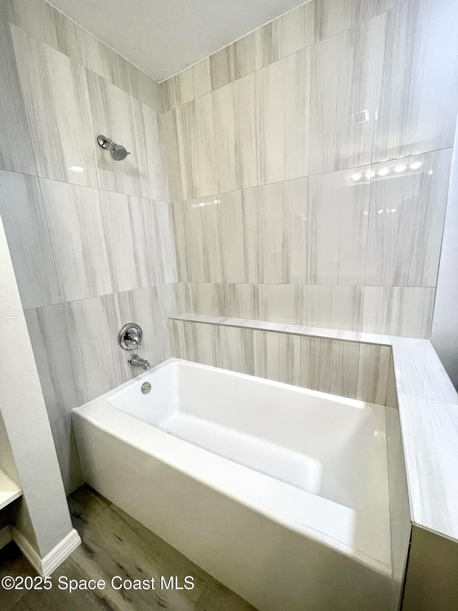 1186 Galty Circle Northeast, Unit 6 Palm Bay, FL 32905 - Photo 20 of 26 a bathroom with a bathtub and shower