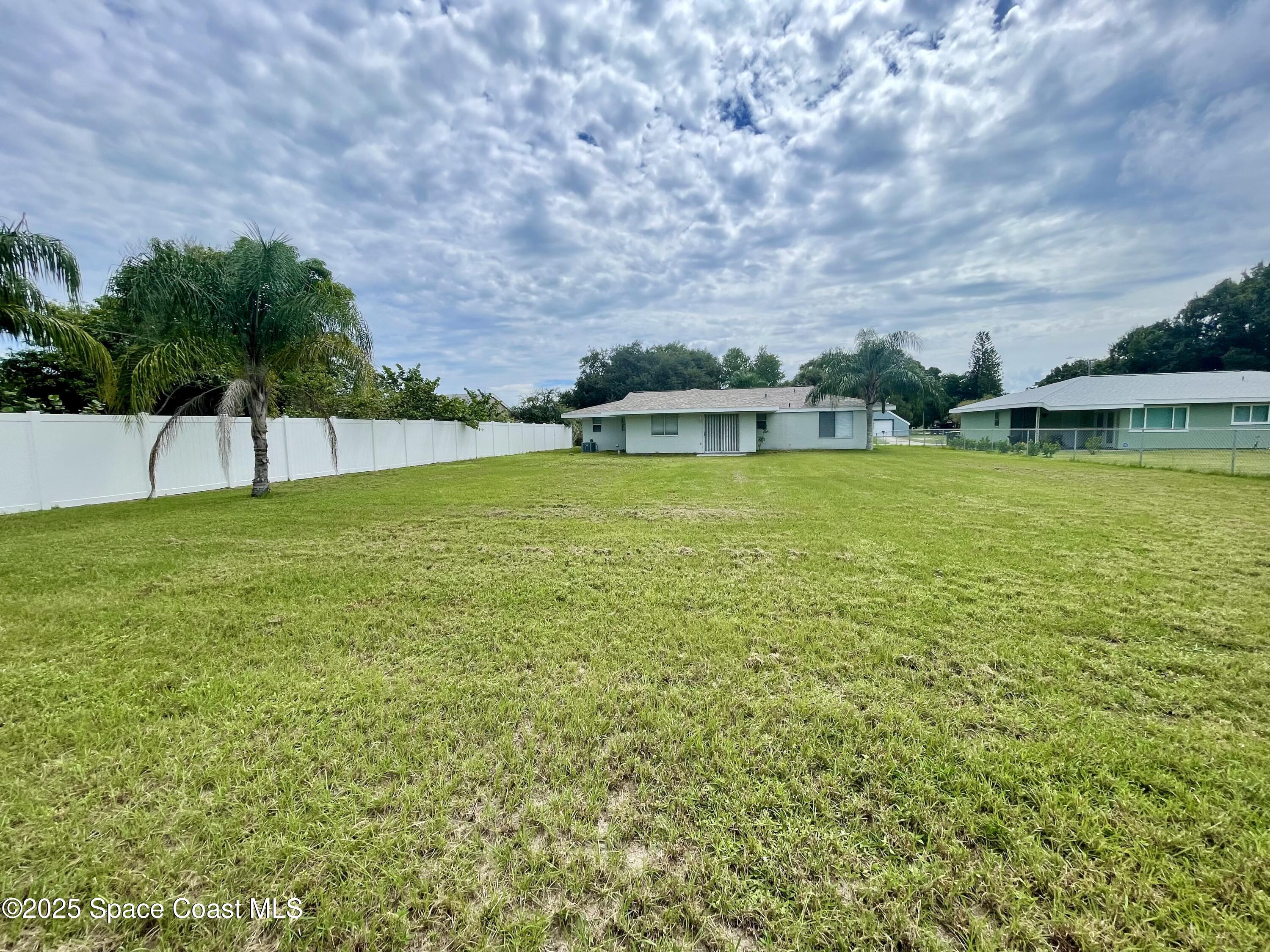 1186 Galty Circle Northeast, Unit 6 Palm Bay, FL 32905 - Photo 25 of 26 a view of an ocean with a house in the background