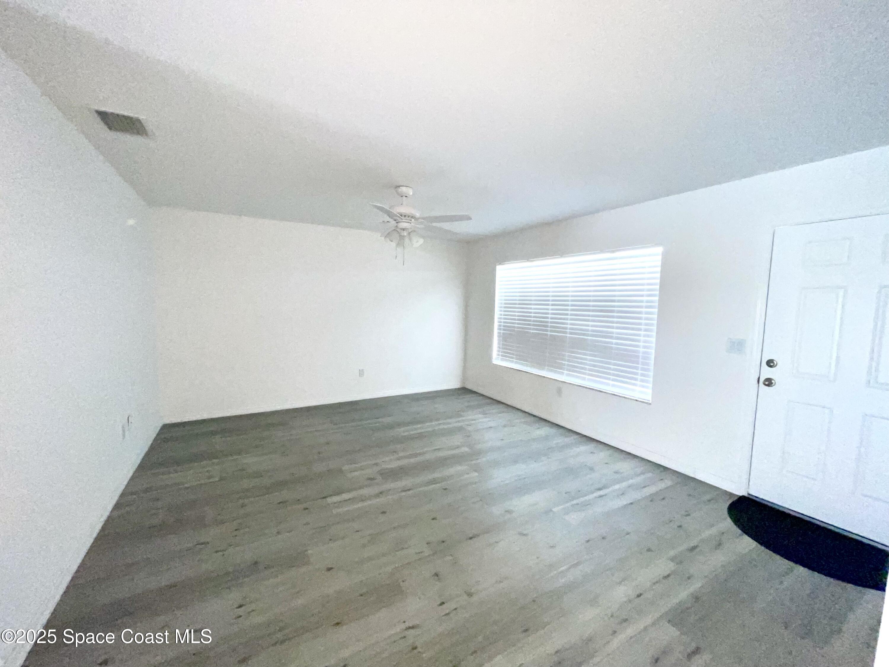 1186 Galty Circle Northeast, Unit 6 Palm Bay, FL 32905 - Photo 4 of 26 wooden floor in an empty room