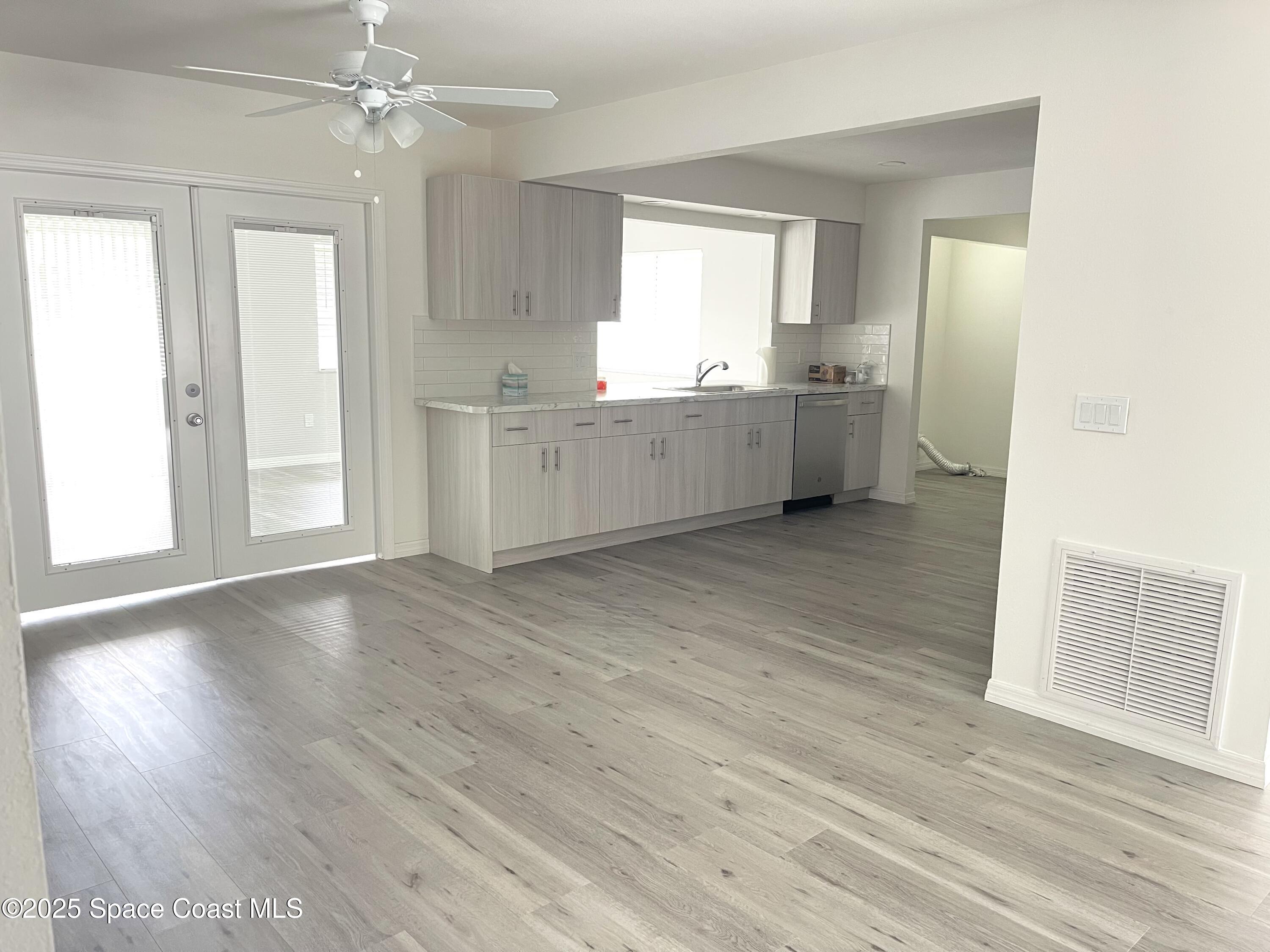 1186 Galty Circle Northeast, Unit 6 Palm Bay, FL 32905 - Photo 5 of 26 a view of a kitchen with wooden floor and a kitchen