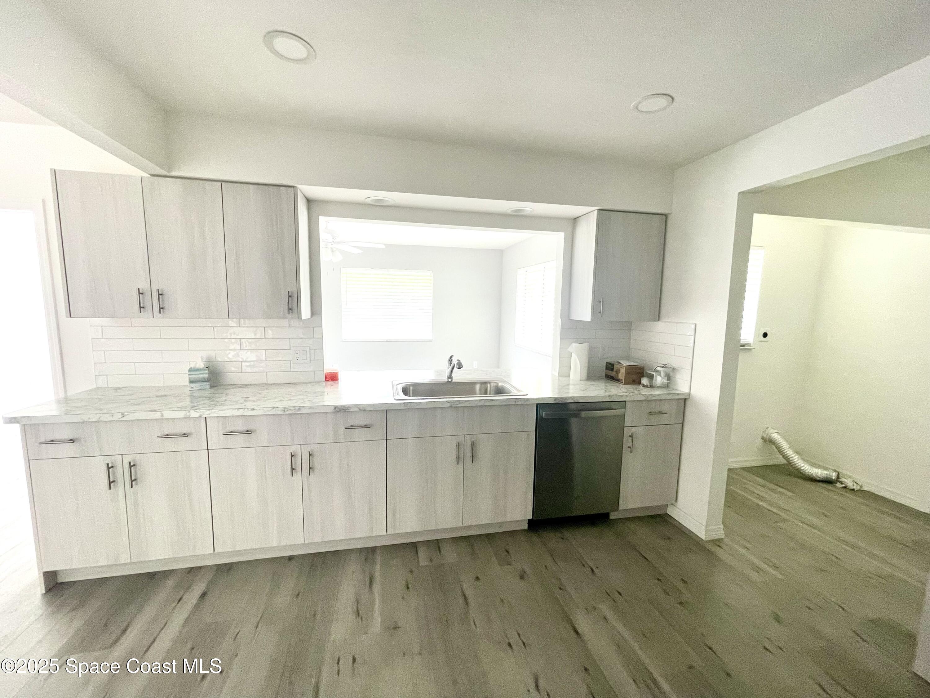1186 Galty Circle Northeast, Unit 6 Palm Bay, FL 32905 - Photo 7 of 26 a view of a kitchen with sink and cabinets