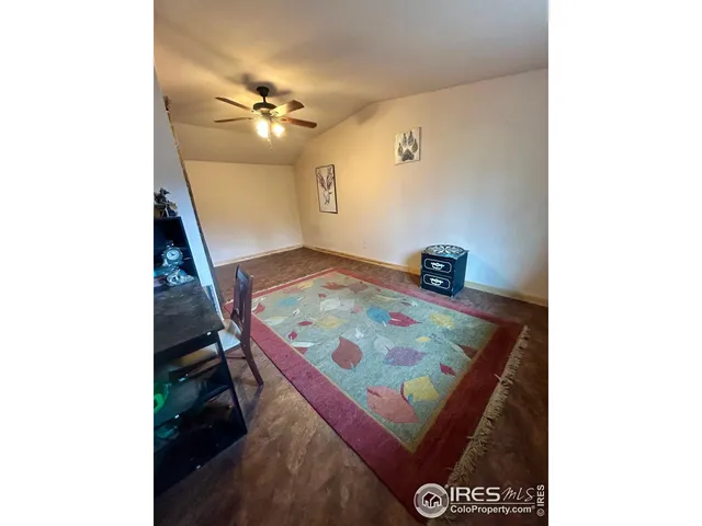 a bedroom with a bed and a lamp on dresser