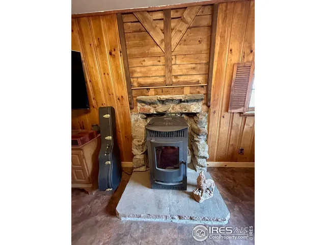 a view of living room with furniture and a fireplace
