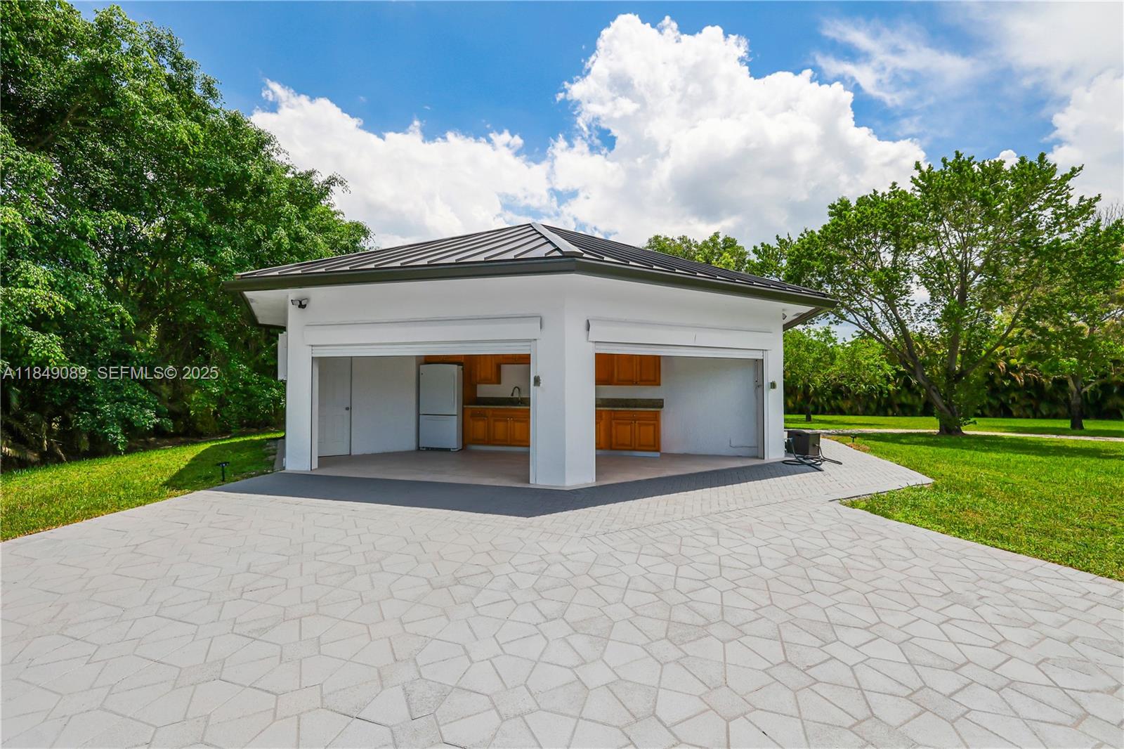 601 Ranch Road Weston, FL 33326 - Photo 51 of 75 One-third is an open-air kitchen with a full pool bathroom (includes shower), ideal for guests or poolside entertaining.