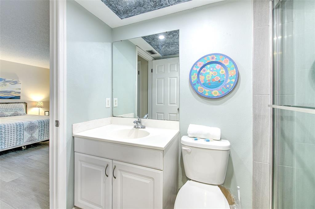 17200 Gulf Boulevard, Unit 401 North Redington Beach, FL 33708 - Photo 20 of 56 a bathroom with a toilet a sink and a mirror