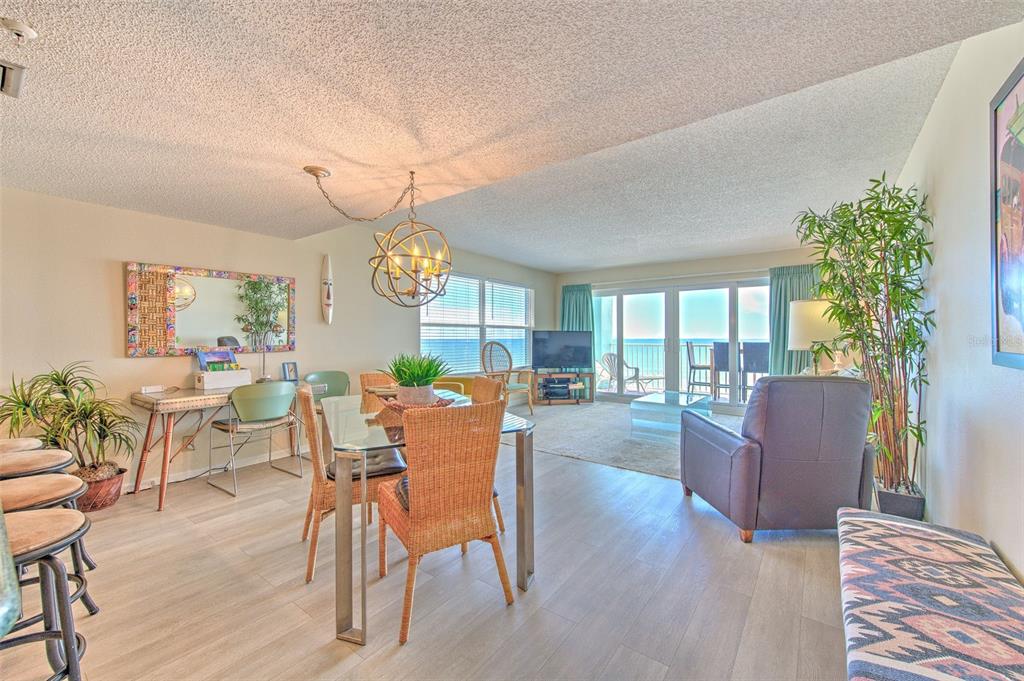 17200 Gulf Boulevard, Unit 401 North Redington Beach, FL 33708 - Photo 2 of 56 a living room with furniture a dining table and a potted plant