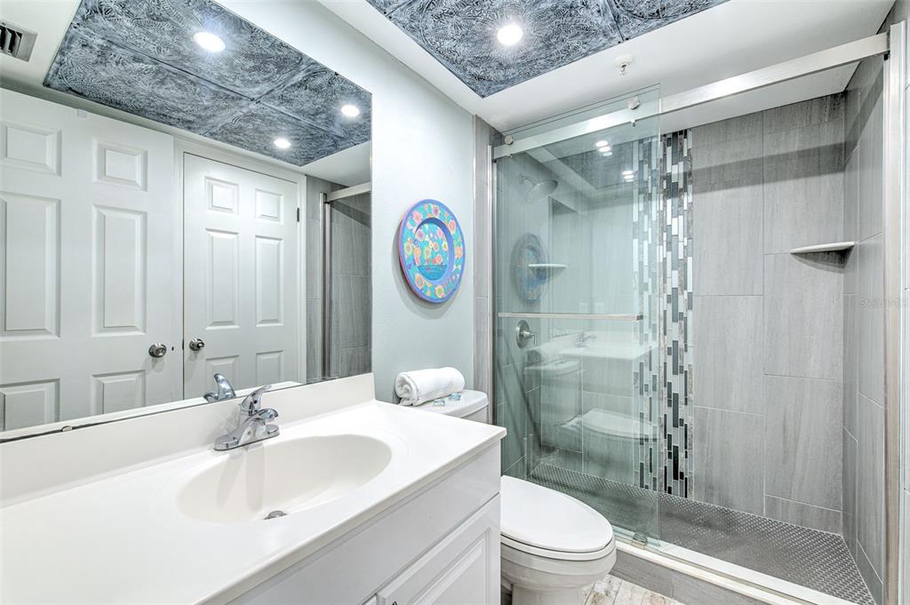 17200 Gulf Boulevard, Unit 401 North Redington Beach, FL 33708 - Photo 21 of 56 a bathroom with a sink a toilet and shower
