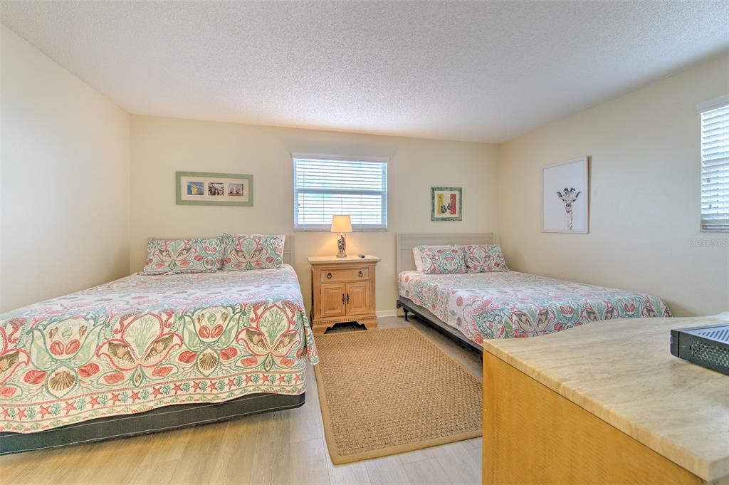 17200 Gulf Boulevard, Unit 401 North Redington Beach, FL 33708 - Photo 23 of 56 a bedroom with a bed and a table in it