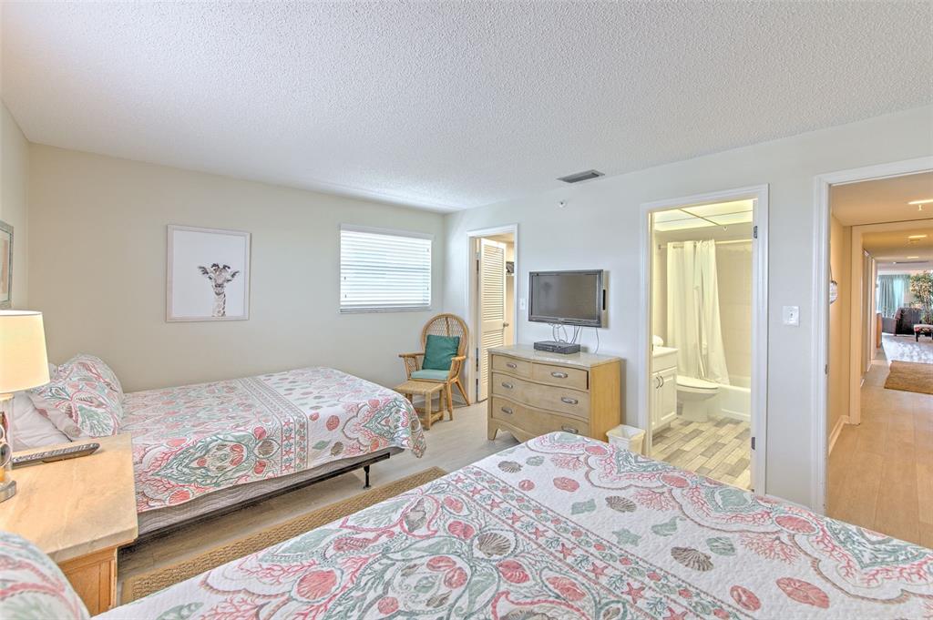 17200 Gulf Boulevard, Unit 401 North Redington Beach, FL 33708 - Photo 24 of 56 a bedroom with a bed and a flat screen tv