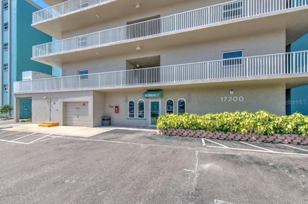 17200 Gulf Boulevard, Unit 401 North Redington Beach, FL 33708 - Photo 39 of 56 a front view of a building with a garden and plants