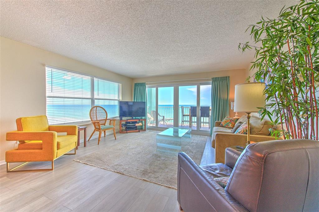 17200 Gulf Boulevard, Unit 401 North Redington Beach, FL 33708 - Photo 4 of 56 a living room with furniture and a floor to ceiling window