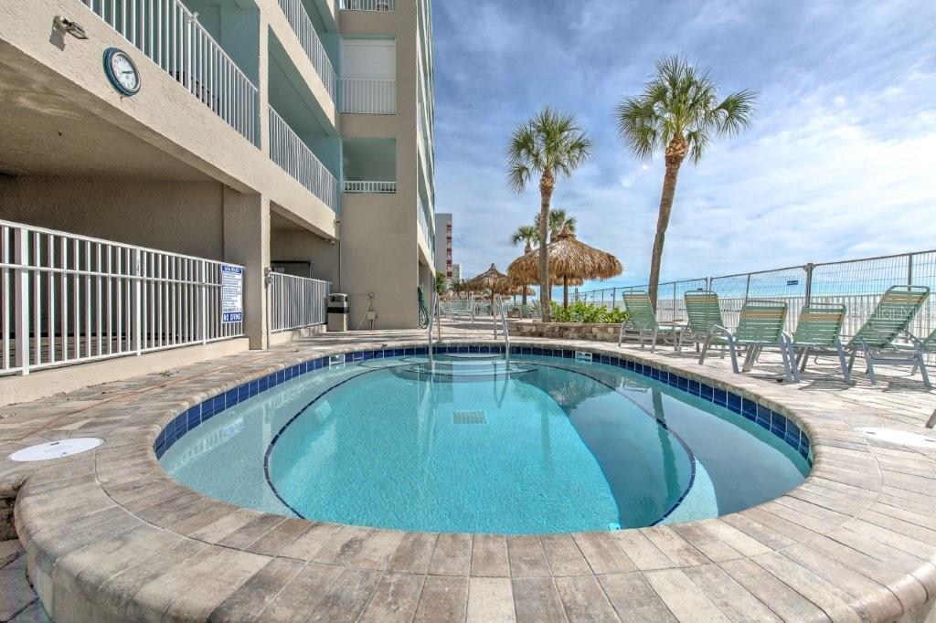 17200 Gulf Boulevard, Unit 401 North Redington Beach, FL 33708 - Photo 48 of 56 a swimming pool with outdoor seating and yard
