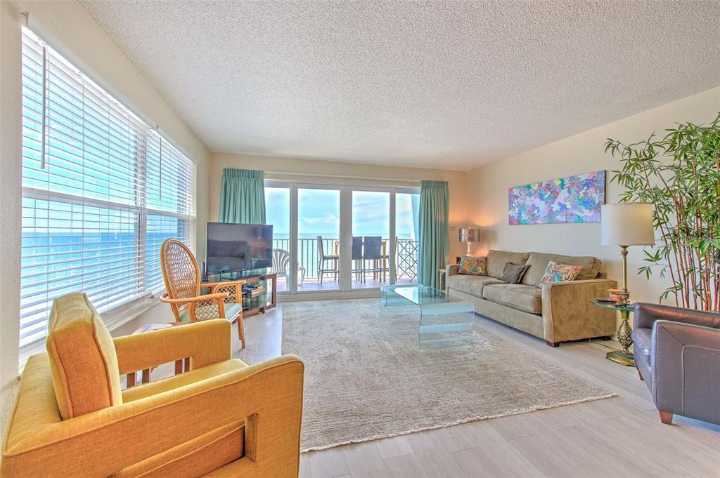 17200 Gulf Boulevard, Unit 401 North Redington Beach, FL 33708 - Photo 5 of 56 a living room with furniture and a flat screen tv
