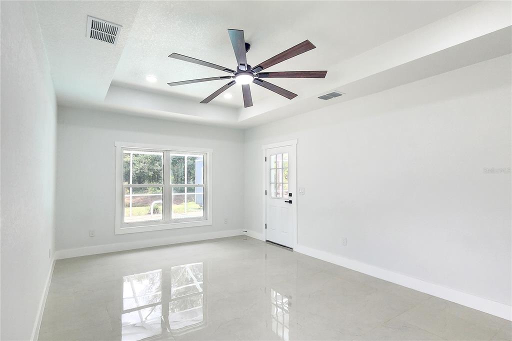 7027 Frascati Loop Wesley Chapel, FL 33544 - Photo 14 of 28 a view of a livingroom with a ceiling fan and window