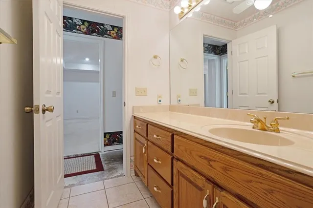 a spacious bathroom with a double vanity sink a mirror and a bathtub