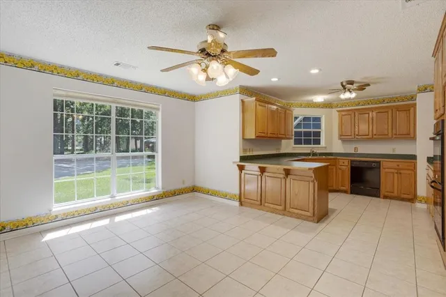 a open kitchen with cabinets a sink and appliances