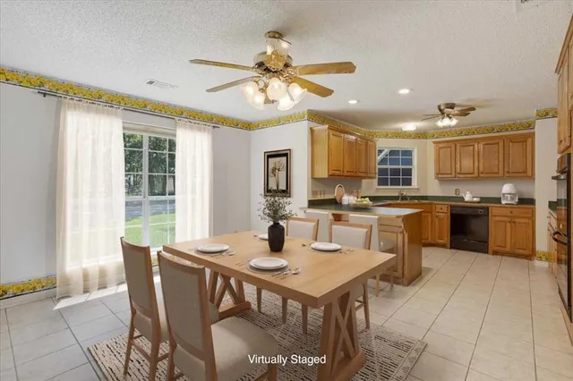a kitchen with a table chairs microwave and cabinets