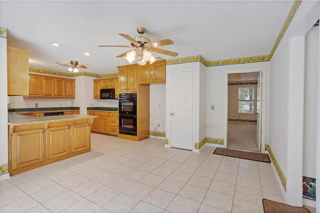 a view of a kitchen with a sink and dishwasher a refrigerator with wooden floor