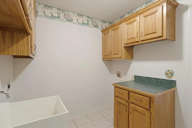 a bathroom with a granite countertop sink and cabinets