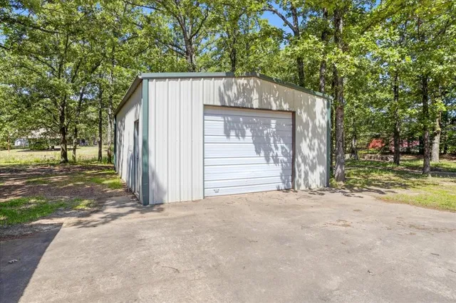 a view of a house with a tree in front of it