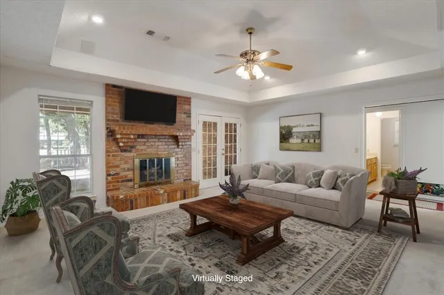 a living room with furniture a flat screen tv and a fireplace